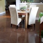 A residential dining room with a polished concrete floor.